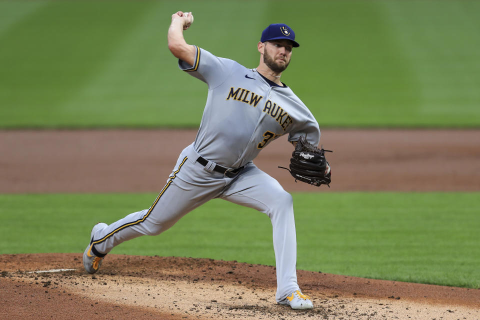 Milwaukee Brewers' Adrian Houser throws during the first inning of the team's baseball game against the Cincinnati Reds in Cincinnati, Wednesday, Sept. 23, 2020. (AP Photo/Aaron Doster)