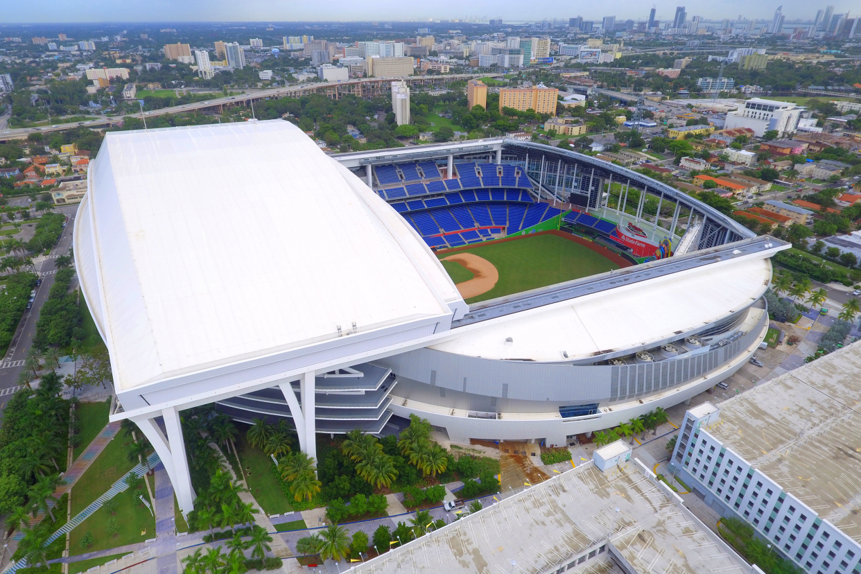 Aerial of opened field in view of LoanDepot Park, Miami, home of the Miami Marlins with surrounding city area