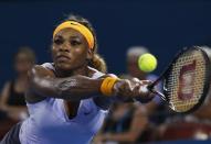 Serena Williams of the U.S. reaches for return to Maria Sharapova of Russia during their women's singles semi final match at the Brisbane International tennis tournament in Brisbane, January 3, 2014. REUTERS/Jason Reed