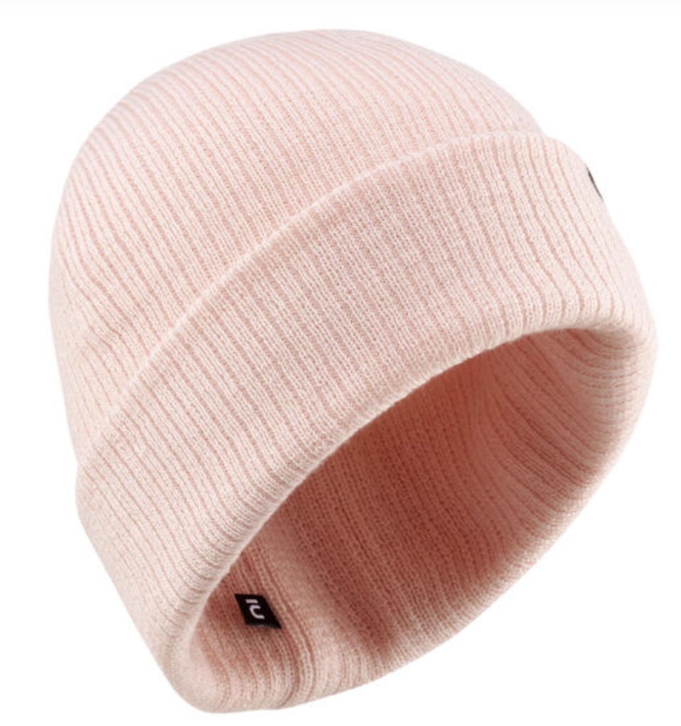 A pink rib knit Wedze Fisherman Adult Ski Beanie with folded cuff brim and small black interior label, set on a white background.