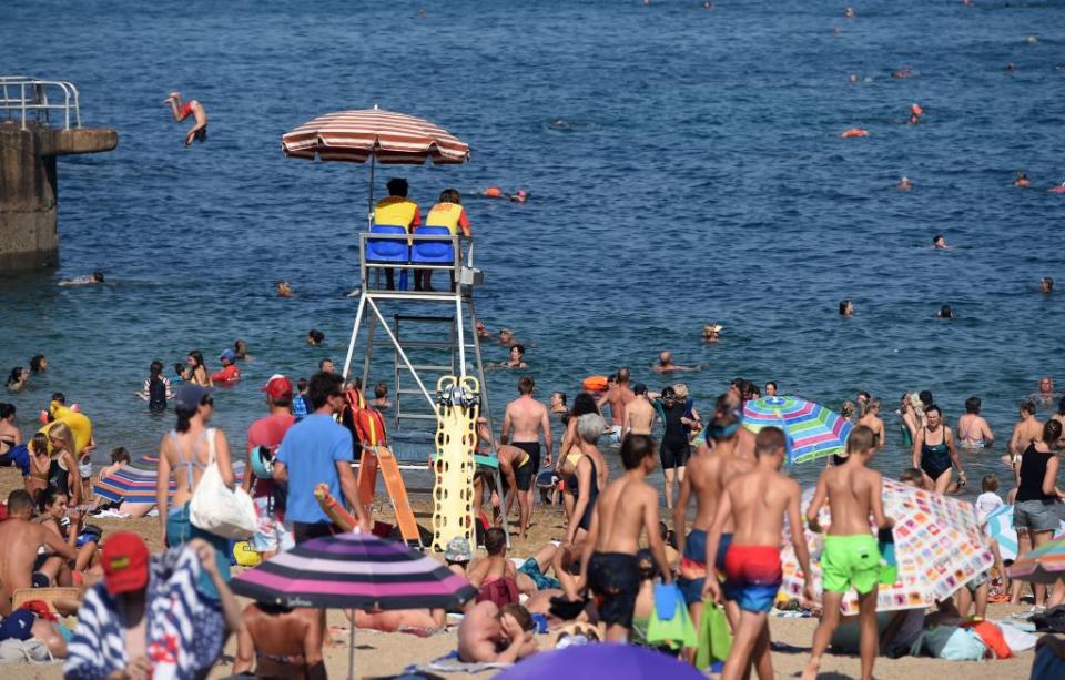 People sunbathe at the at the Port-Vieux beach in Biarritz, southwestern France, on July 30. Source: Getty