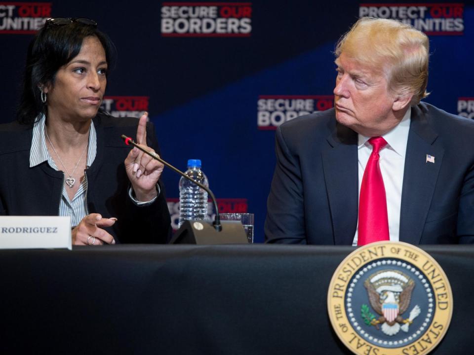 Evelyn Rodriguez speaks with Donald Trump during a roundtable discussion on immigration in New York in May 2018 (SAUL LOEB/AFP/Getty Images)