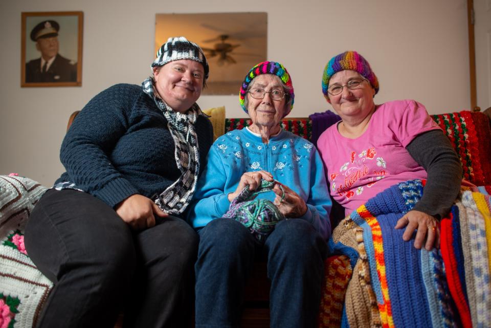 Jacqualin Geasland, middle, is joined by her daughter, Robin Cox, right, and granddaughter Crystal Daggett at her home recently while sporting some of the goods she's crocheted this year. Many of her items are going to children across Topeka.