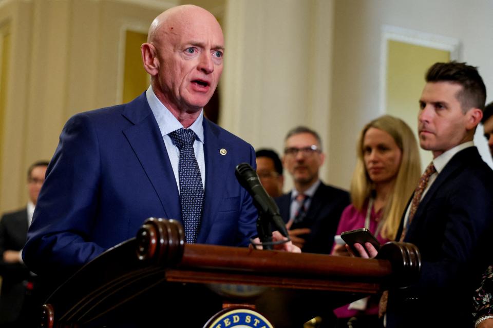 FILE PHOTO: U.S. Sen. Mark Kelly (D-AZ) looks at reporters during a press conference following the weekly Senate caucus luncheons on Capitol Hill in Washington, U.S., April 9, 2024. REUTERS/Amanda Andrade-Rhoades/File Photo