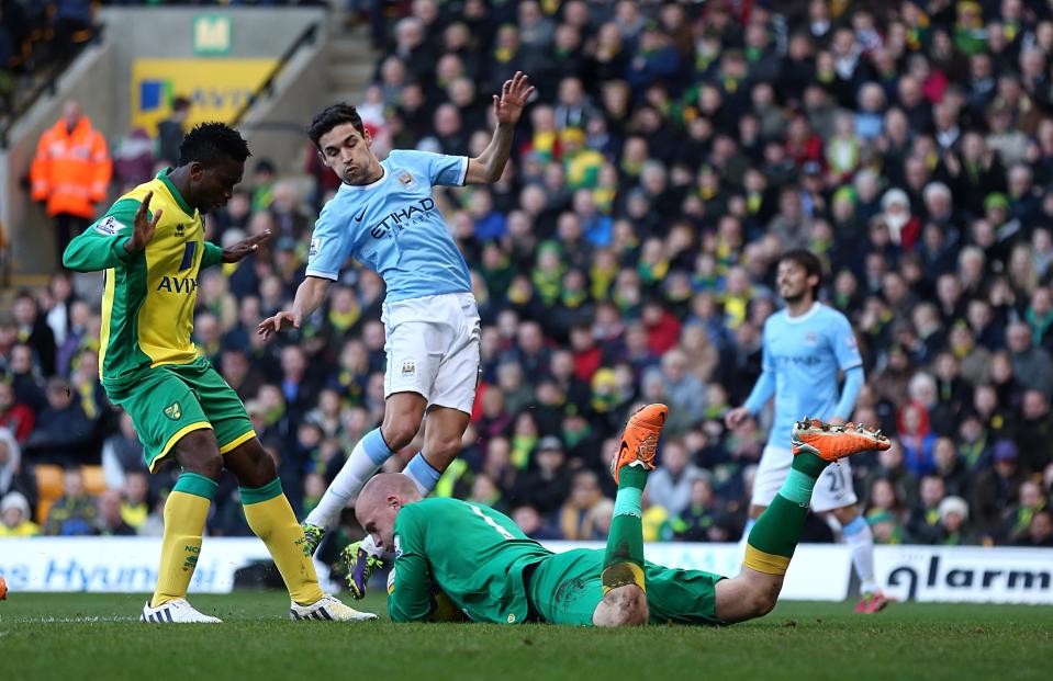 Norwich City's goalkeeper John Ruddy saves at the feet of Manchester City's Gonzalez Jesus Navas during the English Premier League match at Carrow Road, Norwich Saturday Feb. 8, 2014. (AP Photo/ Chris Radburn/PA) UNITED KINGDOM OUT - NO SALES - NO ARCHIVES