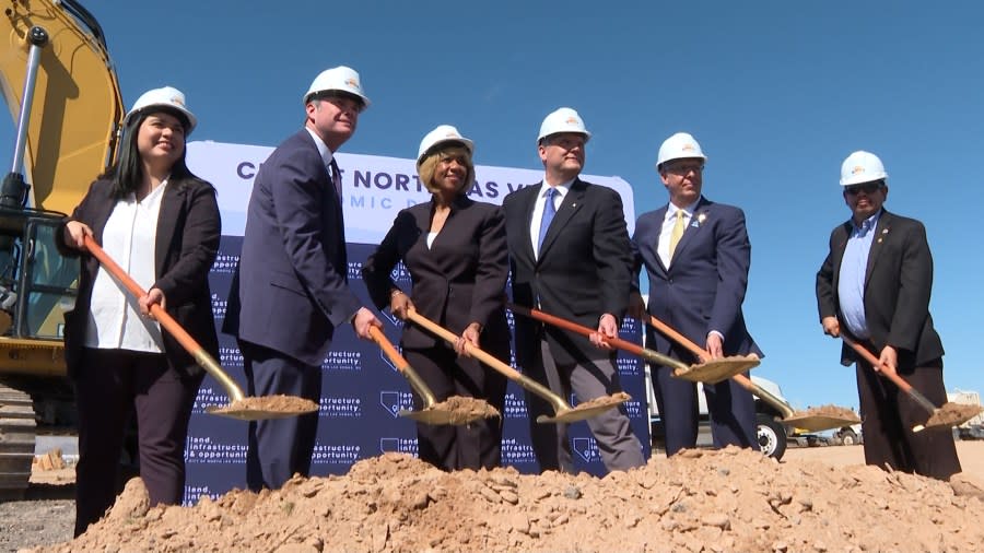 Officials pose for a groundbreaking photo at Apex on Tuesday. (KLAS)