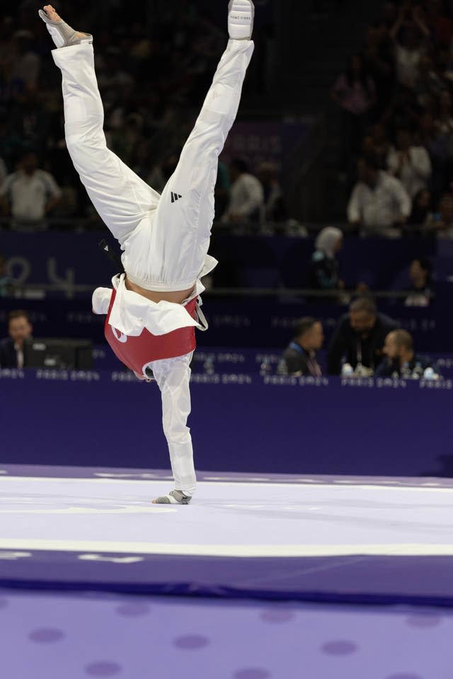 Great Britain’s Amy Truesdale celebrates winning gold in the women's K44 +65kg with a one-handed handstand