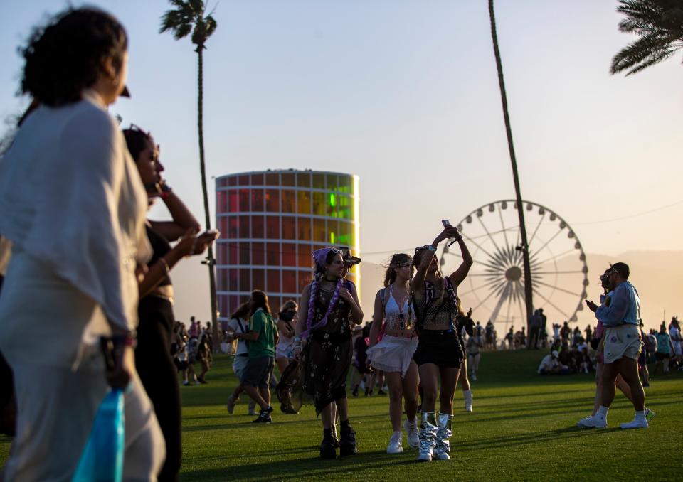 Festivalgoers walk toward the main stage during the Coachella Valley Music and Arts Festival in Indio, Calif., Friday, April 12, 2024.