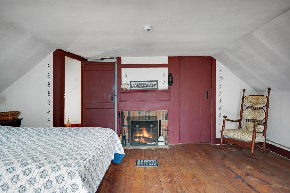 A rocking chair stands in the corner of one of the bedrooms.