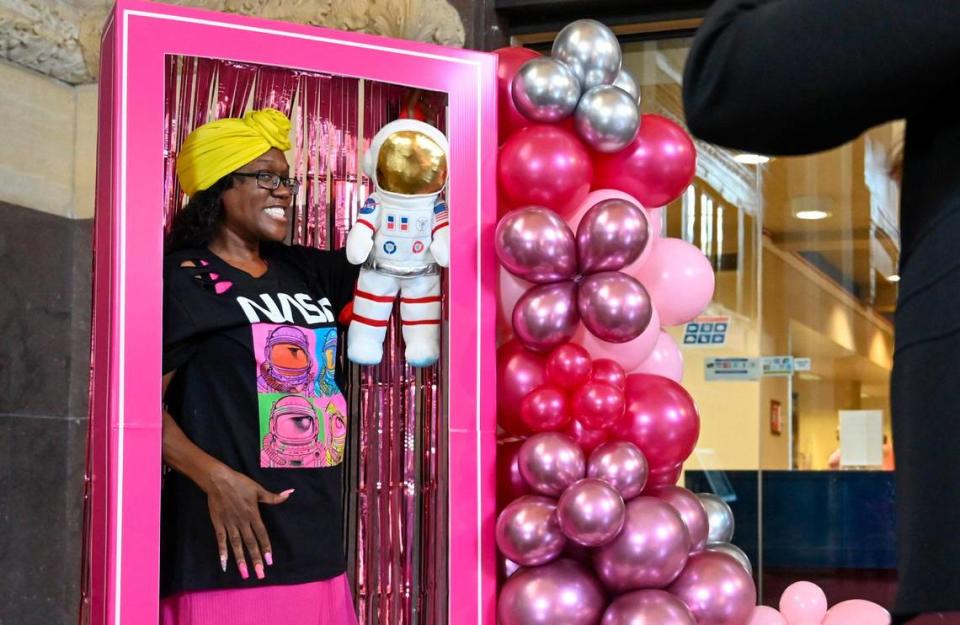 With a Mission Commander doll, Barbie fan Kenya Shobe of Kansas City, posed in a life-size Barbie box to have a photo taken Thursday at Union Station. Tammy Ljungblad/tljungblad@kcstar.com