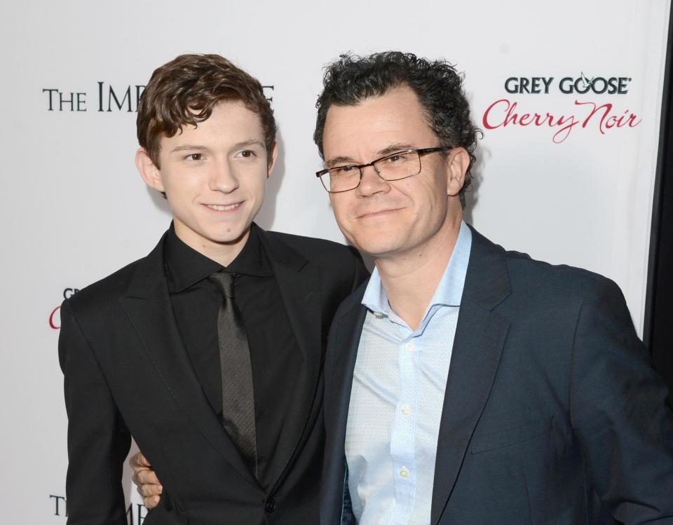 Grins of the father: Dominic Holland with his son Tom: Getty Images