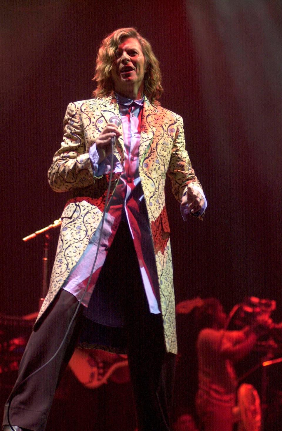 David Bowie performing live onstage at the 2000 Glastonbury festival.