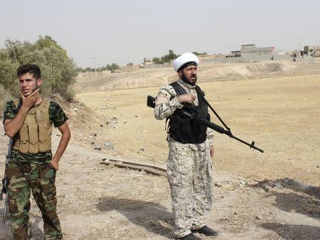 Armed tribal fighters take part in a mission to secure an area from militants of the Islamic State, formerly known as the Islamic State in Iraq and the Levant (ISIL), in the Hamrin mountains in Diyala province July 25, 2014. REUTERS/Stringer