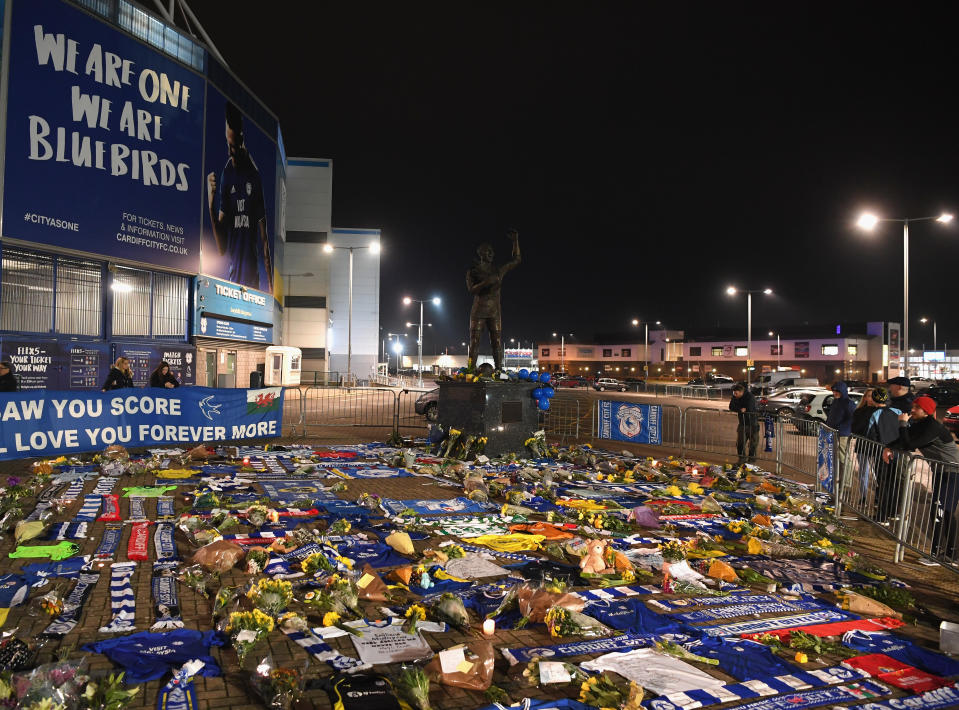 Tributes from Cardiff City fans are shown in front of the Cardiff City Stadium