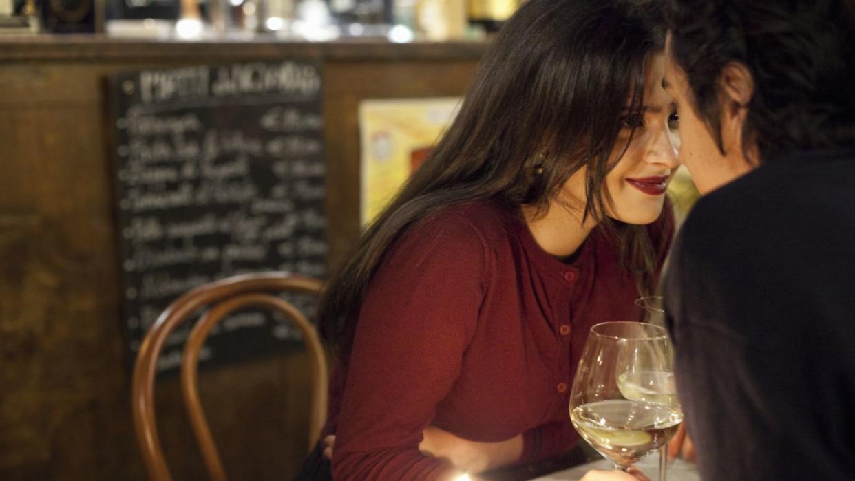 young couple having a romantic moment at a restaurant, rome, italy