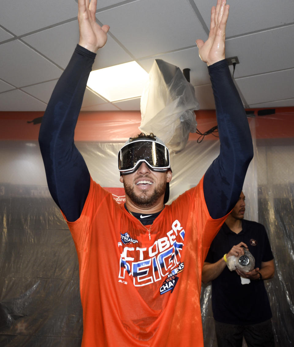 Houston Astros' George Springer celebrates the team's clinching of the AL West crown after a baseball game against the Los Angeles Angels, Sunday, Sept. 22, 2019, in Houston. (AP Photo/Eric Christian Smith)