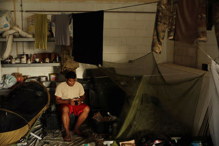 A soldier from the First Armored Division's Combat Aviation Brigade prepares in his sleeping quarters during recovery efforts following Hurricane Maria at their base in Roosevelt Roads Naval Station, Puerto Rico, October 8, 2017. REUTERS/Lucas Jackson