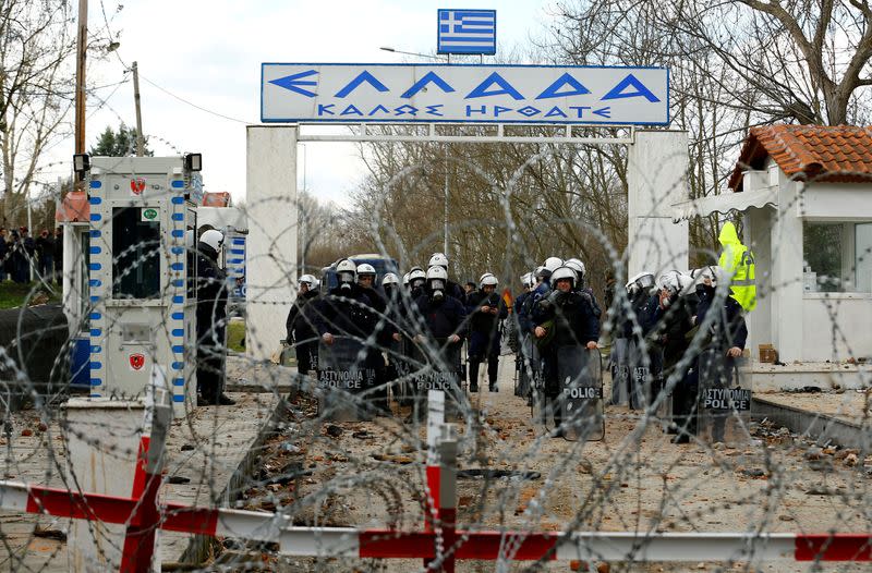 Greek police officers are pictured from Turkey's Pazarkule border crossing with Greece's Kastanies, in Edirne