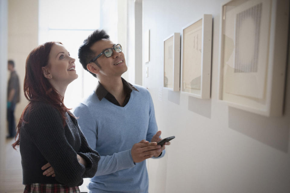 Two people looking at art in a museum