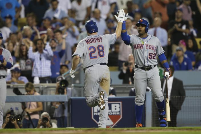 New York Mets&#39; Daniel Murphy gets a high five from teammate Yoenis Cespedes after hitting a home run.