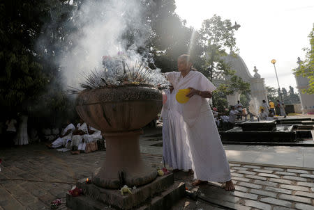 A Buddhist devotee worships at the Kelaniya Buddhist temple during Vesak Day, commemorating the birth, enlightenment and death of Buddha, in Colombo, Sri Lanka May 18, 2019. REUTERS/Dinuka Liyanawatte