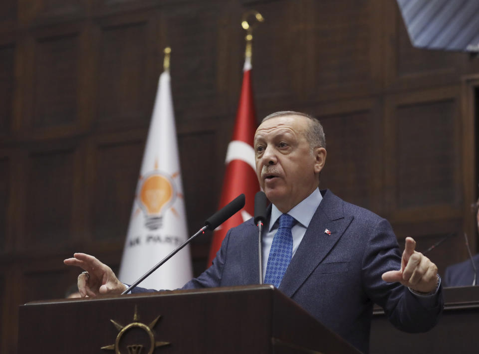 Turkish President Recep Tayyip Erdogan addresses the members of his ruling party in Parliament, in Ankara, Turkey, Wednesday, March 11, 2020. Erdogan vowed on Wednesday to respond with greater military force to action by Syria's government that would break a fragile cease-fire in Syria's northwestern Idlib province, that was brokered last week. (AP Photo/Burhan Ozbilici)