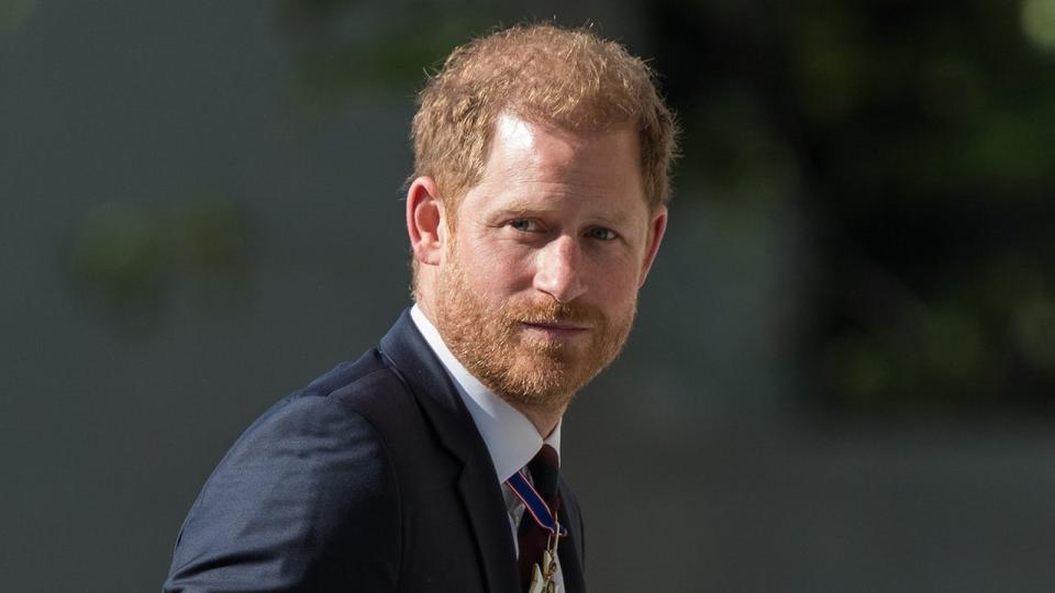 Prince Harry in a dark suit looking to the side