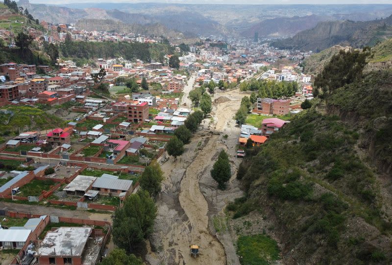 River flooding due to rain affects homes, in La Paz