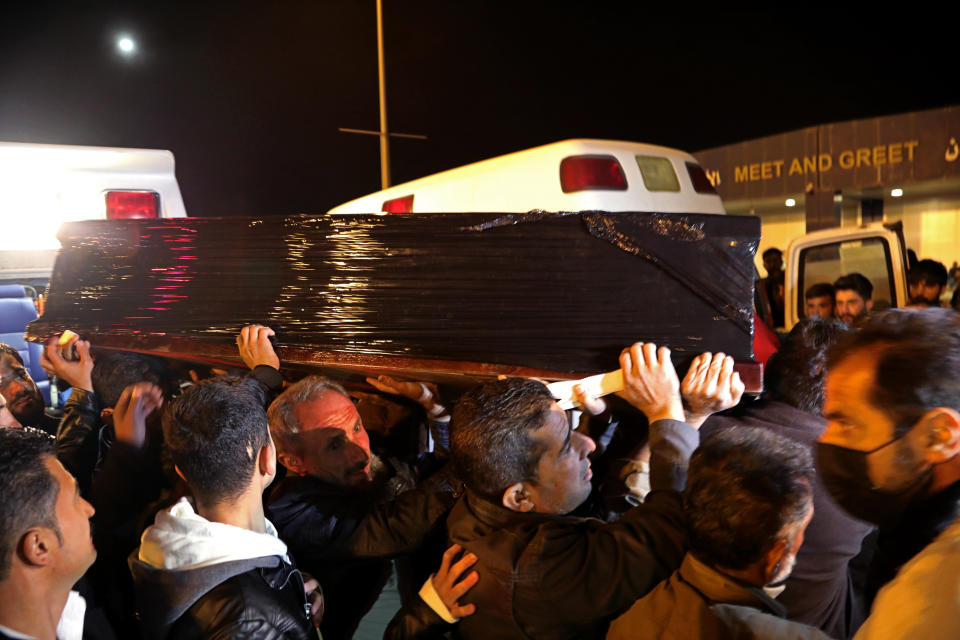 The body of Gaylan Delir Ismael, 25, from Iraq's Kurdish region, arrives at Irbil Airport, Iraq, early Monday, Nov. 15, 2021. Like thousands of other Iraqis and Syrians, Gaylan had traveled to Belarus on an easily obtained tourist visa in the hope of getting to Germany and starting a new life. But he never made it there, dying in a dark and soggy forest on the Belarus-Poland border. (AP Photo)
