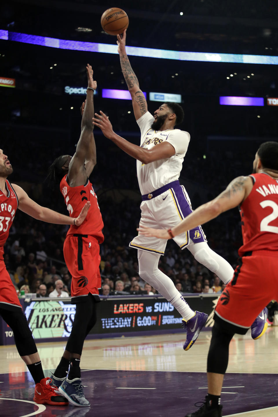 Los Angeles Lakers' Anthony Davis shoots over Toronto Raptors' Chris Boucher during the first half of an NBA basketball game Sunday, Nov. 10, 2019, in Los Angeles. (AP Photo/Marcio Jose Sanchez)