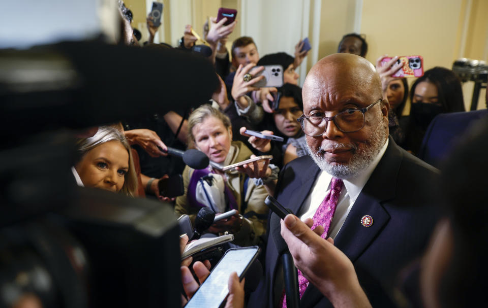 Rep. Bennie Thompson, lips pursed, surrounded by a mob of reporters and their microphones and videocameras.