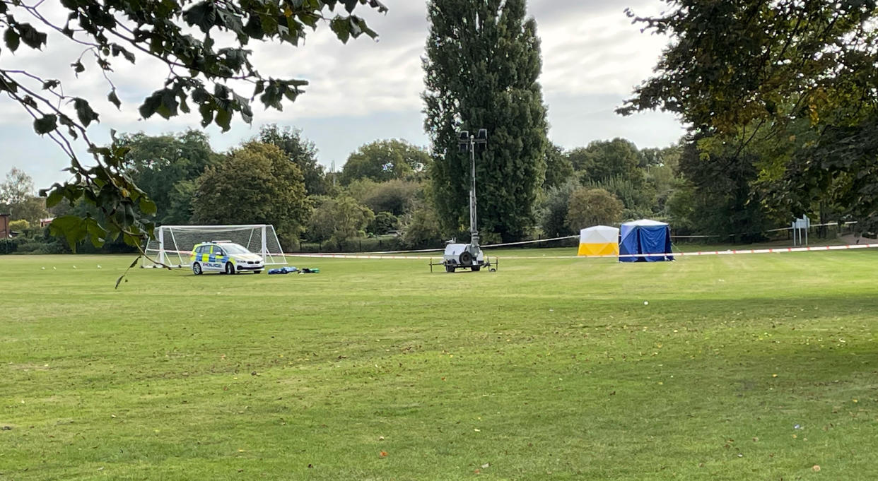 A police car and forensic tents at the scene on a playing field in Craneford Way, Twickenham.