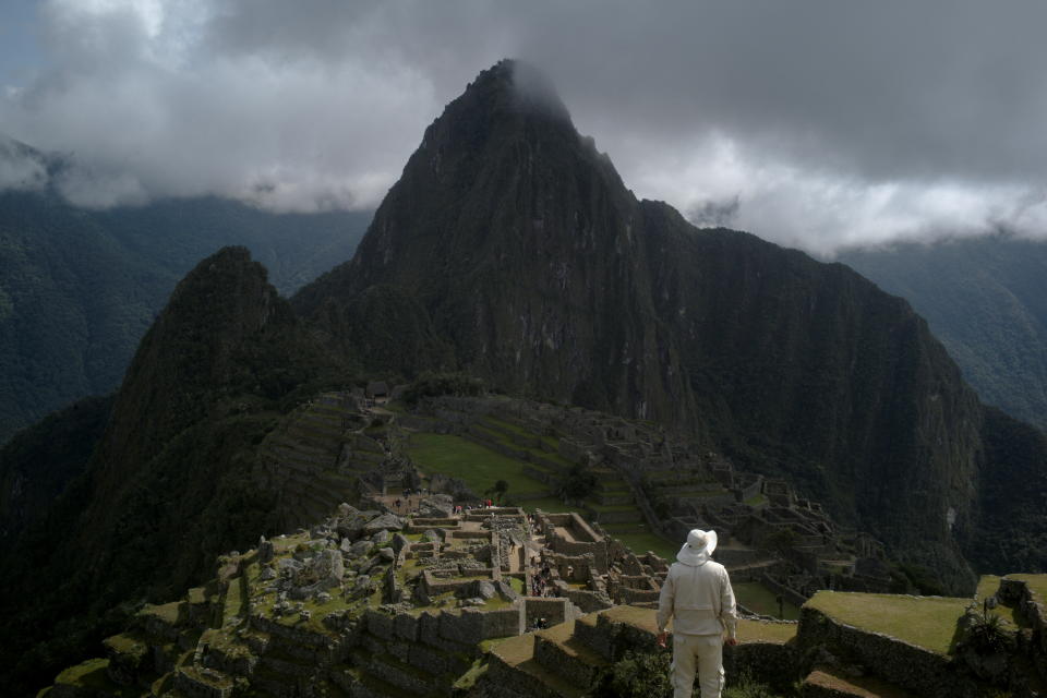 A man stands near the Incan ruins of Machu Picchu, a tourism magnet, access to which is being limited by local protests against rising prices amid a worldwide surge most recently triggered by the Russian invasion of Ukraine, outside of Cuzco, Peru April 18, 2022. Picture taken April 18, 2022. REUTERS/Alessandro Cinque