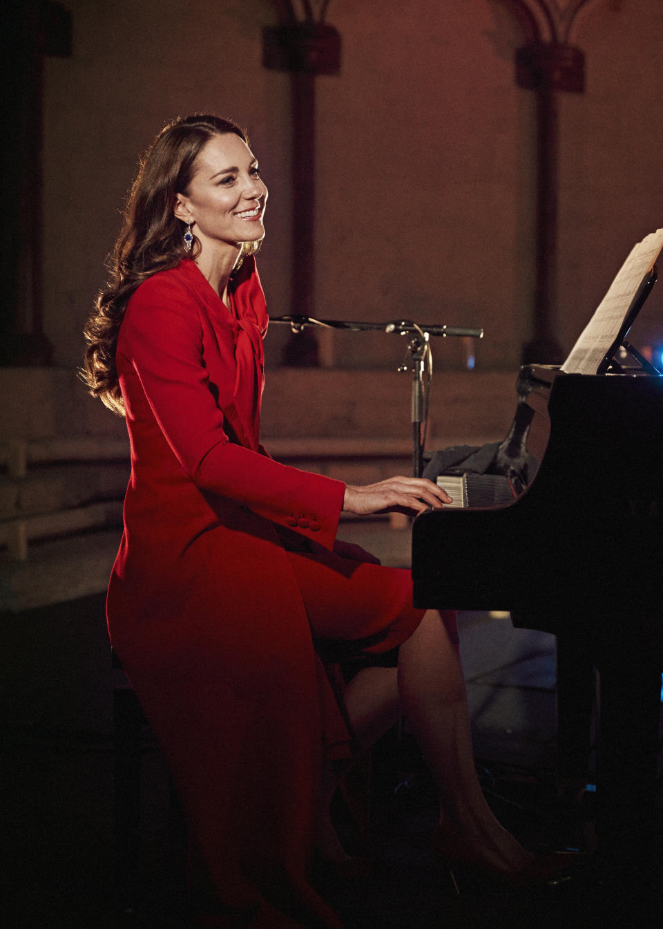 In this image released December 24, 2021, Catherine, Duchess of Cambridge accompanies singer Tom Walker on the piano during a performance of his song 'For Those Who Can't Be Here' during Royal Carols - Together At Christmas, a Christmas carol concert host (Alex Bramall / Getty Images)