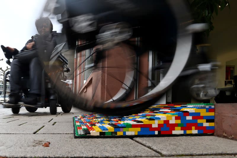 Rita Ebel, nicknamed "Lego grandma", tests one of her wheelchair ramps built from donated Lego bricks in Hanau