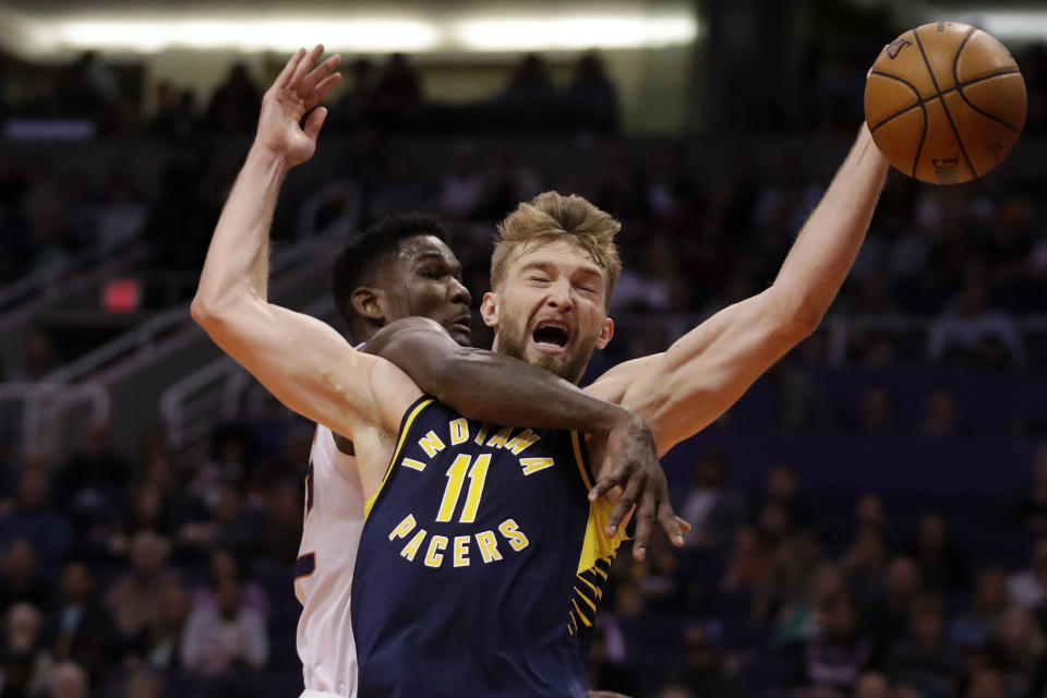 Indiana Pacers forward Domantas Sabonis (11) is fouled by Phoenix Suns center Deandre Ayton during the first half of an NBA basketball game, Wednesday, Jan. 22, 2020, in Phoenix. (AP Photo/Matt York)