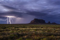 <p>Rain and lightning bolts hammer the desolate terrain of Monument Valley, Ariz. (Photo: Jennifer Khordi/Caters News) </p>