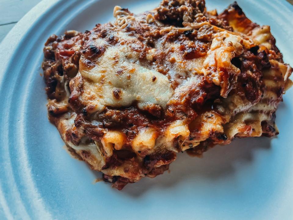 piece of cooked lasagna on a white plate