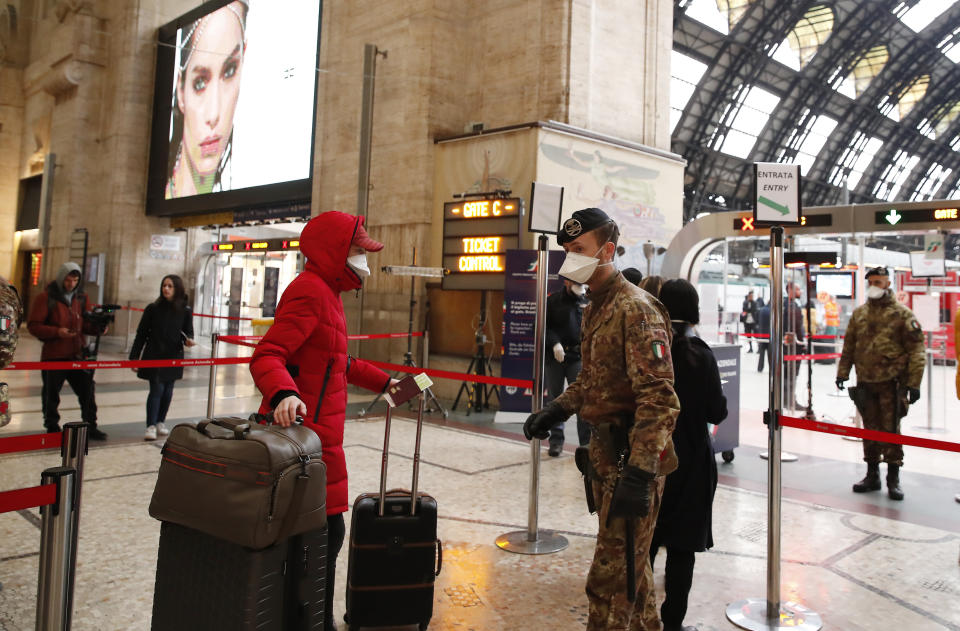 Police officers and soldiers check passengers leaving from Milan main train station, Italy, Monday, March 9, 2020. Italy took a page from China's playbook Sunday, attempting to lock down 16 million people — more than a quarter of its population — for nearly a month to halt the relentless march of the new coronavirus across Europe. Italian Premier Giuseppe Conte signed a quarantine decree early Sunday for the country's prosperous north. Areas under lockdown include Milan, Italy's financial hub and the main city in Lombardy, and Venice, the main city in the neighboring Veneto region. (AP Photo/Antonio Calanni)