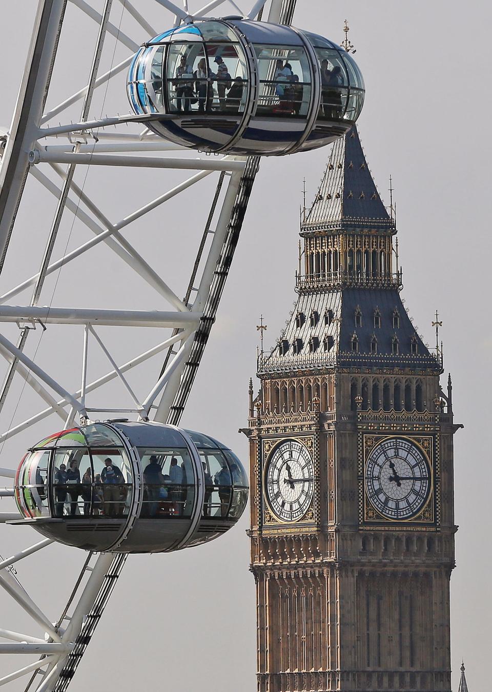 People on the London Eye look at London landmark  Big Ben during a a bright  September morning in London, Friday, Sept. 11, 2015.(AP Photo/Frank Augstein) ORG XMIT: FAS101