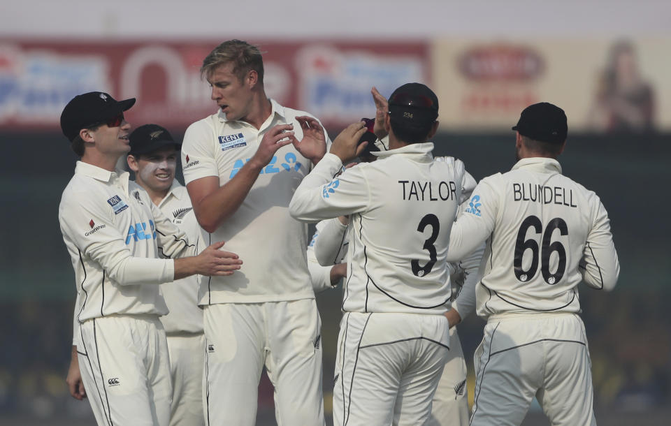 New Zealand's Kyle Jamieson celebrates the dismissal of India's Mayank Agarwal with his teammates during the day one of their first test cricket match in Kanpur, India, Thursday, Nov. 25, 2021. (AP Photo/Altaf Qadri)