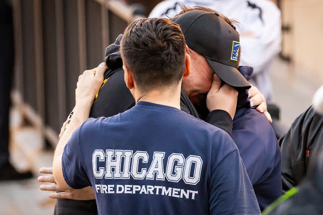 <p>Ashlee Rezin/Chicago Sun-Times via AP</p> Chicago Fire Department personnel mourn outside Advocate Illinois Masonic Medical Center after a firefighter passed after battling an early morning blaze in Chicago, Monday, Nov. 13, 2023. Firefighter Andrew "Drew" Price, 39, who joined the department in 2009, was taken from the fire to Illinois Masonic where he died of his "significant injuries," authorities said.