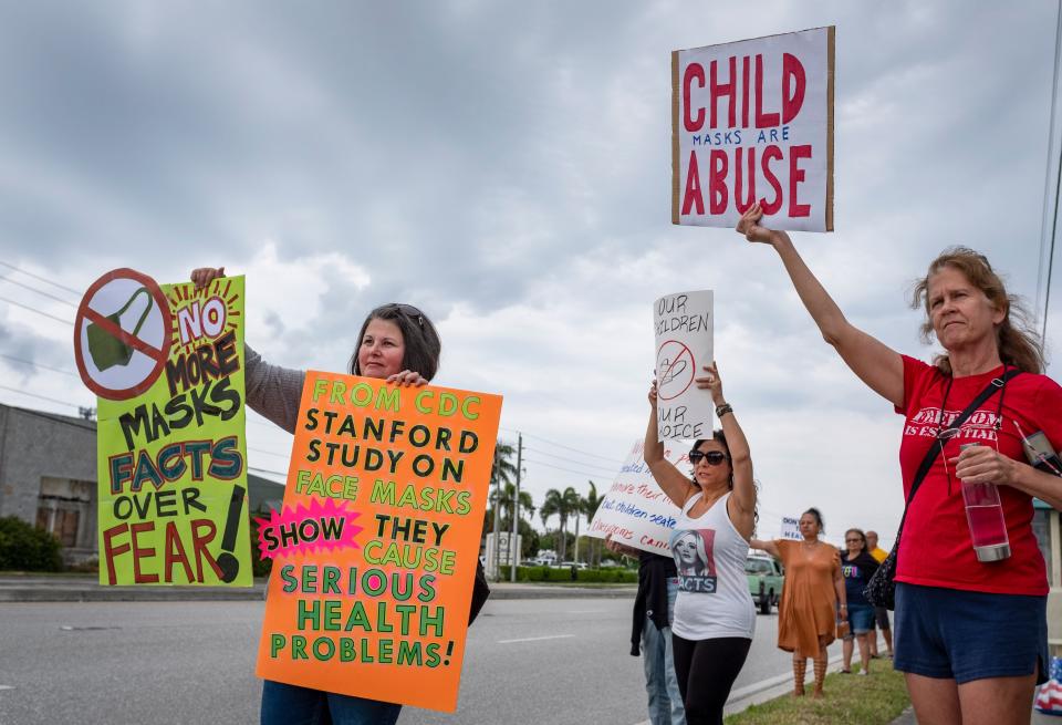 Anti-mask demonstrators stand along Forest Hill Boulevard outside the Palm Beach County School District offices during a school board meeting in 2021.