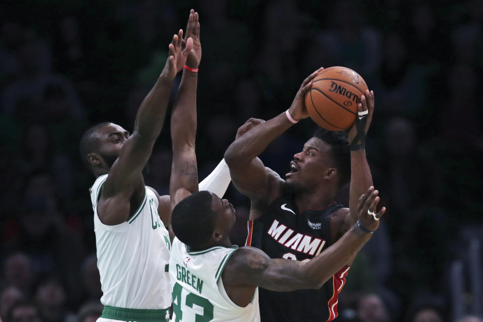 Miami Heat forward Jimmy Butler, right, is covered on his shot by Boston Celtics guard Javonte Green (43) and forward Jaylen Brown, rear left, during the first half of an NBA basketball game in Boston, Wednesday, Dec. 4, 2019. (AP Photo/Charles Krupa)