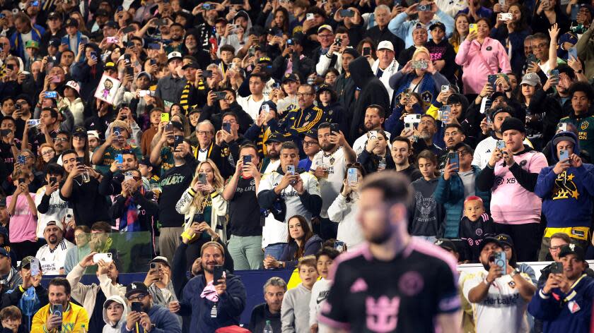 Carson, California February 25, 2024-Fans take pictures and video as Miami's Lionel Messi prepares for a corner kick against Galaxy in the first half at Dignity Health Sport Park Sunday. (Wally Skalij/Los Angeles Times)