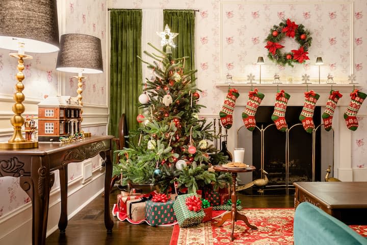 photo of Home Alone house interior on Airbnb with stockings and a Christmas tree near fireplace