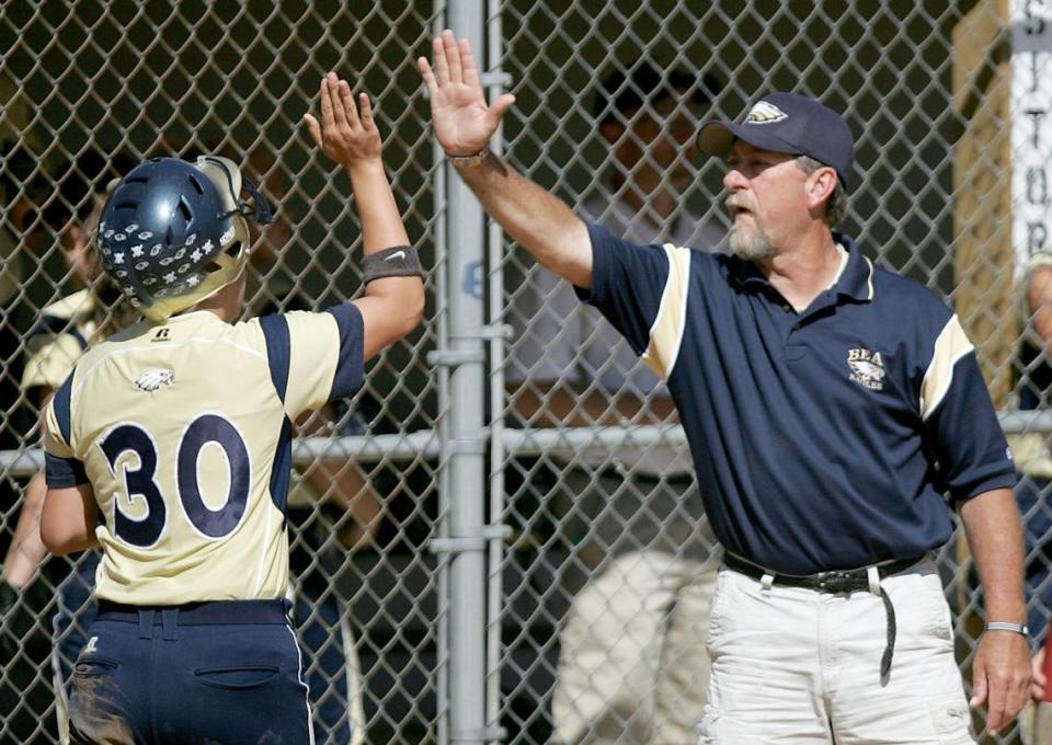 Bald Eagle coach Dave Breon high-fives Jasa Mitchell after she scored a run against Penns Valley on Wednesday, May 20, 2009.