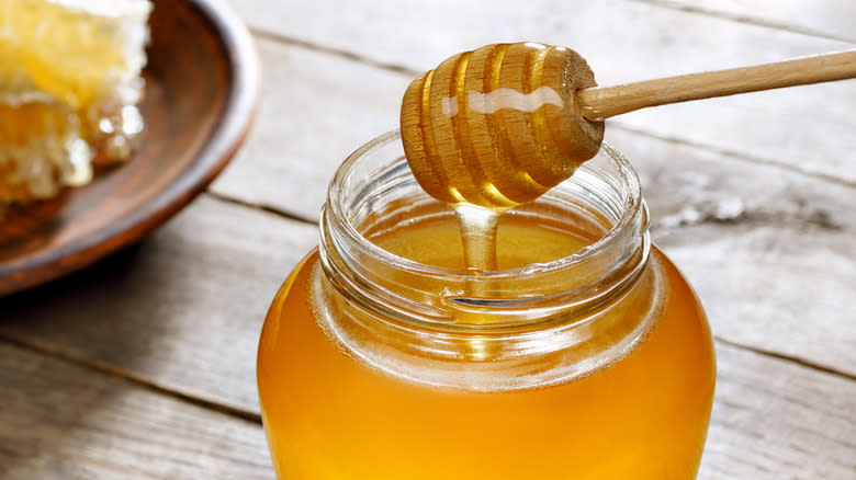 close up of honey in a jar