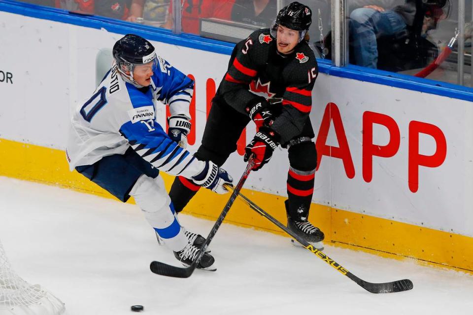 Aug 20, 2022; Edmonton, Alberta, CAN;Team Canada forward Brennan Othmann (15) makes a pass in front of Team Finland defensemen Kasper Puutio (10) during the first period in the championship game during the IIHF U20 Ice Hockey World Championship at Rogers Place. Mandatory Credit: Perry Nelson-USA TODAY Sports