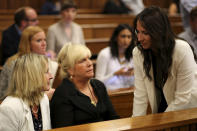 Aimee Pistorius, sister of Oscar Pistorius, right, talks to June Steenkamp, left, mother of the late Reeva Seenkamp, and friend Jenny Strydom, center, before court hearings begins in Pretoria, South Africa, Monday March 17, 2014. Oscar Pistorius is on trial for the murder of his girlfriend Reeva on Valentines Day 2013. (AP Photo/Siphiwe Sibeko, Pool)